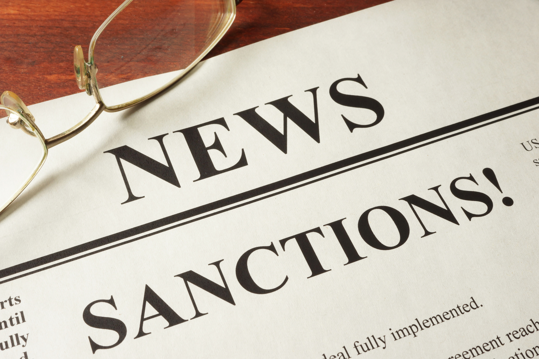 Newspaper with word news and sanctions