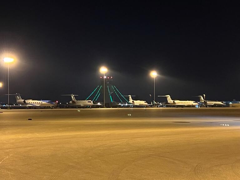 Many planes lined up at air control tower