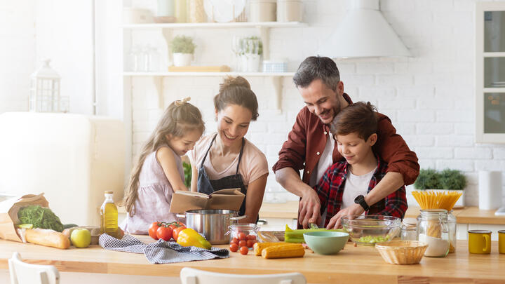Happy family cooking together on home kitchen