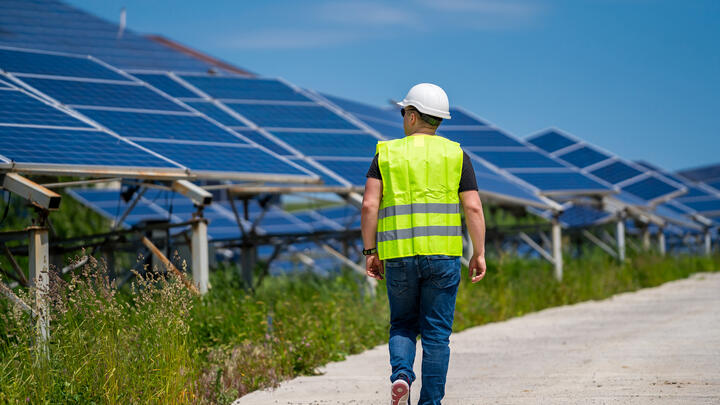 man walking solar panels