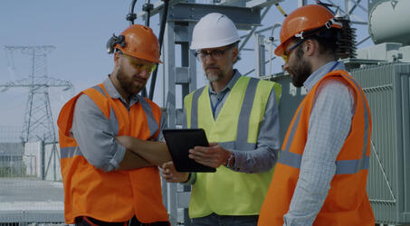 energy workers reviewing tablet