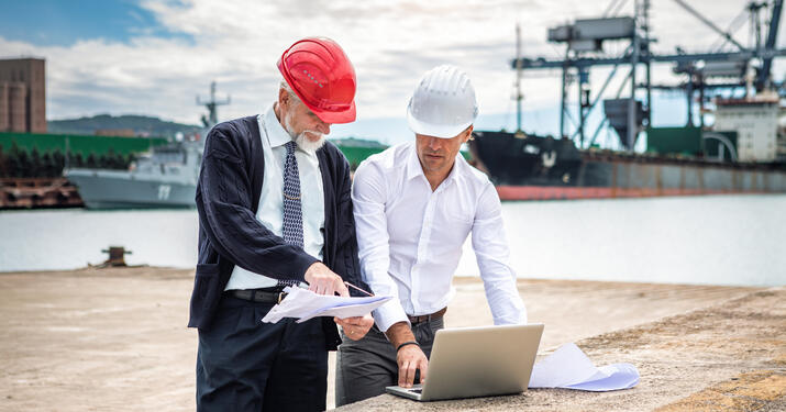 two engineers working by seaport