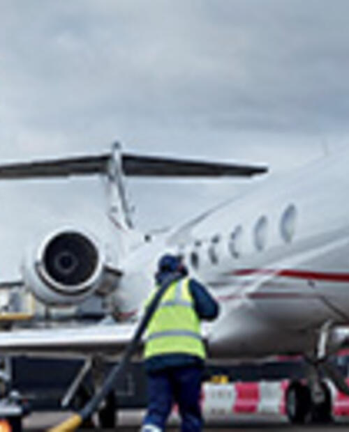 person fueling airplane